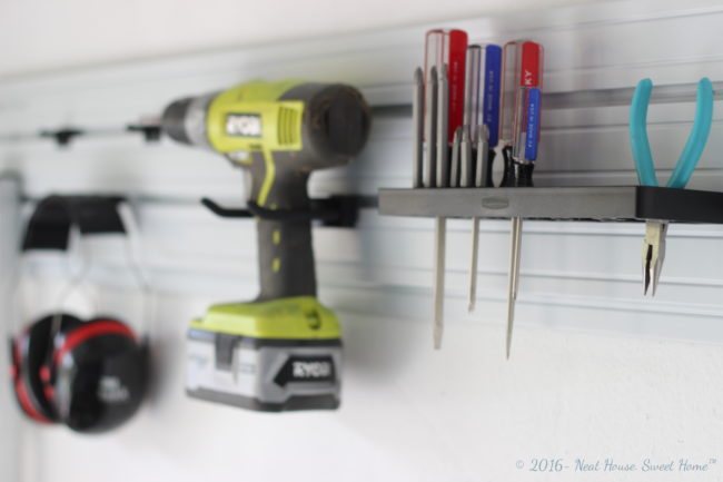 How to install vertical storage in the garage walls. Clean up your garage with Rubbermaid® FastTrack® Garage Organization System. #GarageCleanUp #ad